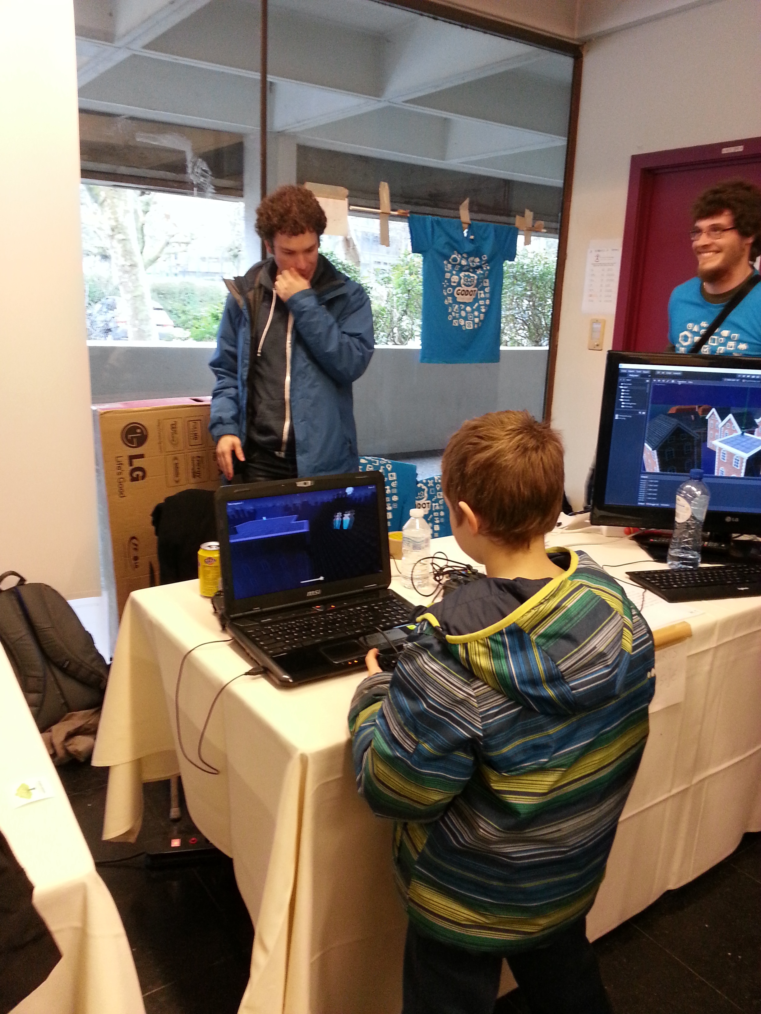 Photo of a child playing a game at Godot's FOSDEM booth