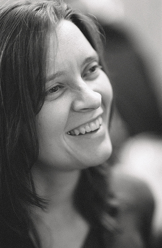 Black and white picture of Allison Randal smiling in profile
