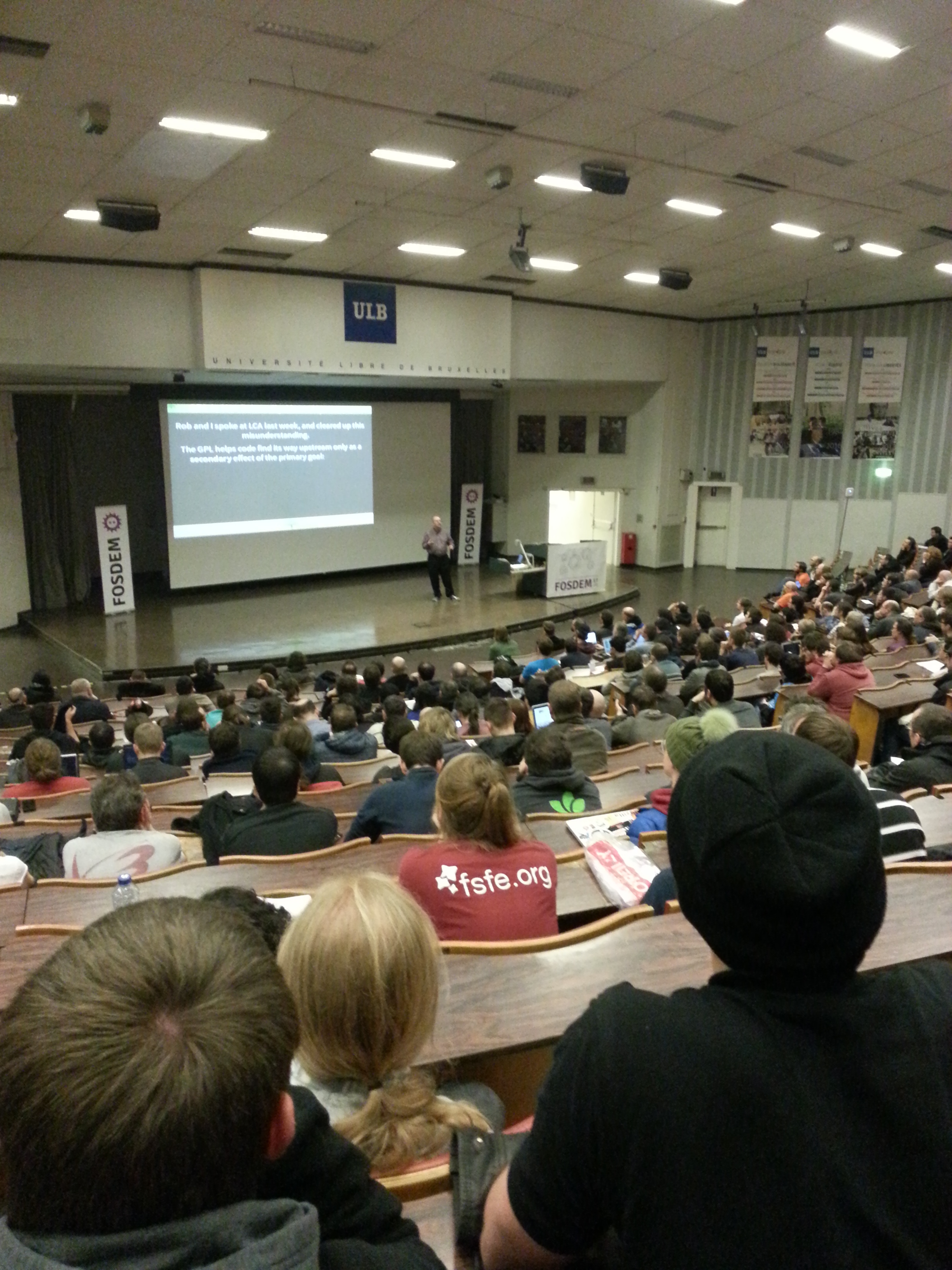 Photo of Bradley Kuhn delivering his keynote at FOSDEM