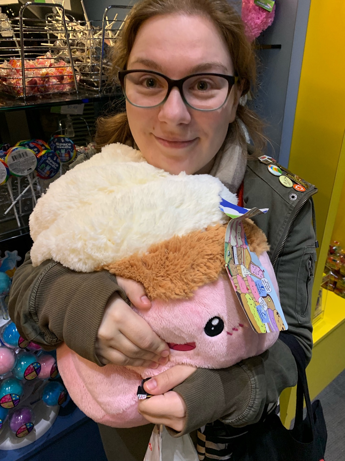 Elana hugging a plush cupcake toy.