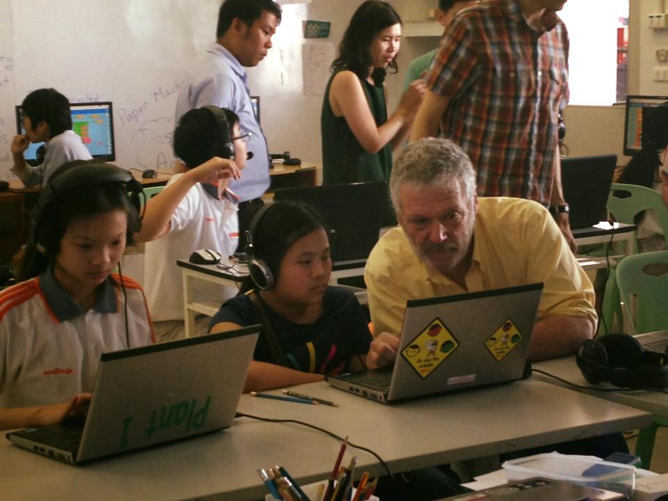 A photograph of Walter Bender helping children at Turtle Art Day