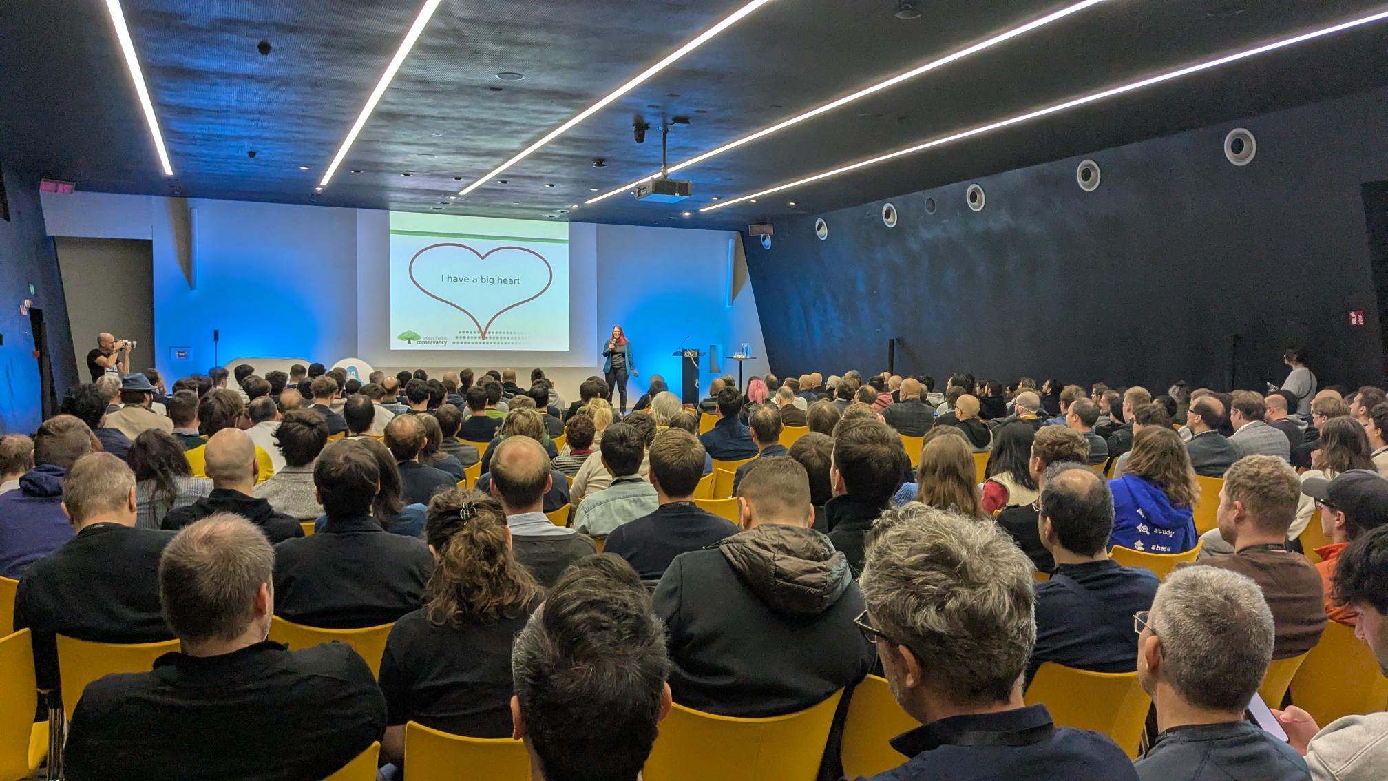 Photo of Karen speaking in front of large crowd at SFSCon