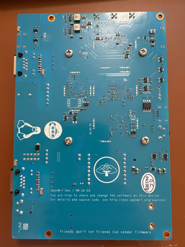 Picture of OpenWrt One PCB showing Software Freedom Conservancy logo and offer for source